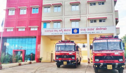 A completed fire station with appliances in the bays.