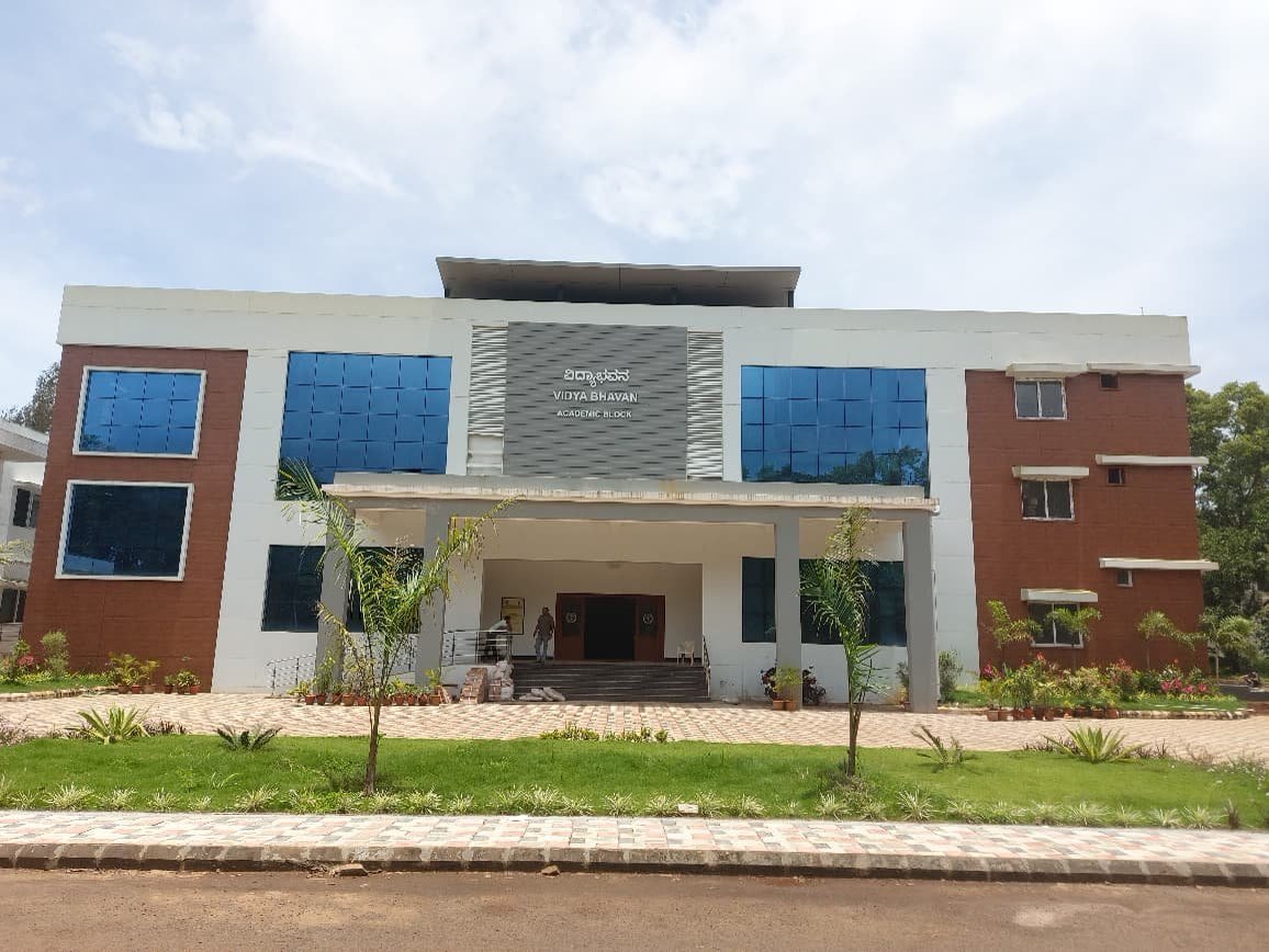 Vidya Bhavan at VTU Belagavi, a completed multi storey block with blue glazing.